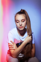 Teen girl in stylish clothes. Trend photos in 90s style. Toning photos with highlights.