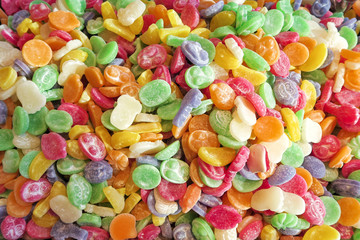 Flat top view of multicolored chewing marmalade. Texture of dessert marmalade with a sharp and sweet-sour taste. Jelly candies in bright red, yellow, green and orange colors.      