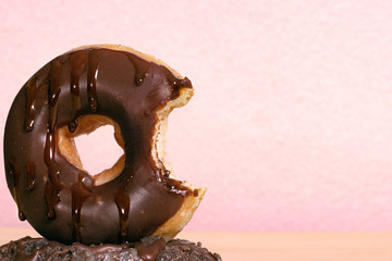 classic chocolate donut with chocolate drops pretending to melt