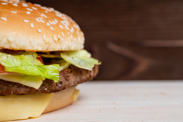 Burger on a wooden background. Rating concept. Copy space.