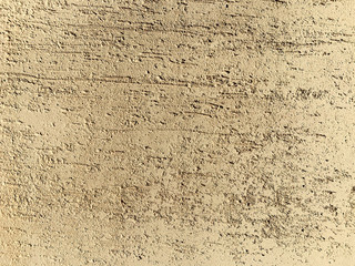 Scratched wall surface covered by decorative stucco. Painted putty. Decorative construction materials. Abstract background texture pattern with copyspace