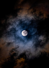 Naklejka na ściany i meble Super Moon on a dark, cloudy sky on March, 9th 2020
