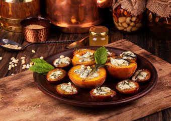 Grilled baked peach and plums stuffed with blue cheese dorblu and rosemary.