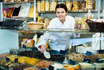 Girl in uniform  selling candied fruits and nuts