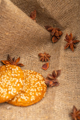 Cookies and star anise on a background of coarse fabric. Close up.
