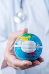 doctor man showing a globe with a mask