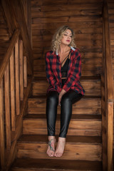 Cozy time at home. Cute plus size blonde woman at wooden interior , lifestyle 