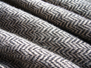 The texture of the fabric. Gray knit fabric with geometric patterns of wool and cotton.