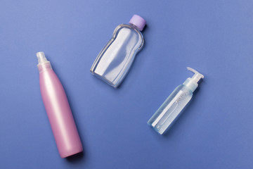 purple and blue cosmetic bottles on blue background