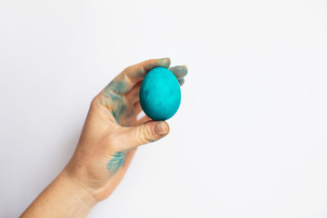 Blue Easter egg in woman hand on white background. Easter concept