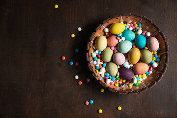Obraz na płótnie Canvas Easter decoration, easter eggs on a wooden background