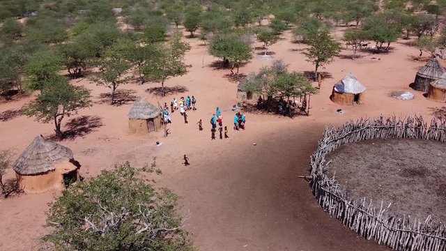 Drone footage of a village of people Himba during tourist visit, Namibia