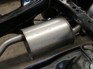 fine closeup image of metal silencer in a pickup truck. Exhaust Pipe