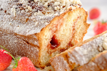 Tasty and fragrant cupcake with strawberries and almonds with a crispy crust on a white plate