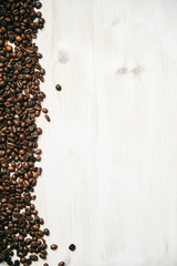 Wood background with coffee beans on the sides