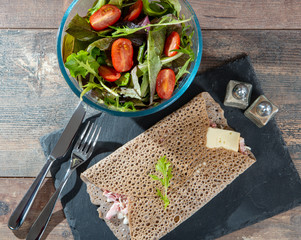 Breton crepe with cheese and bacon on wooden background