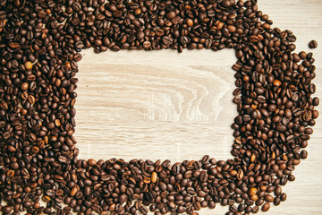 Frame of coffee beans on wood background, copy space