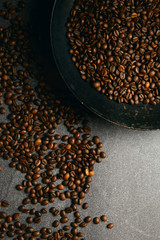 Vertical top view of roast coffee pan and beans on ardesia table
