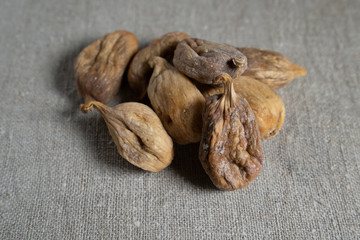 Large dried figs on burlap, closeup