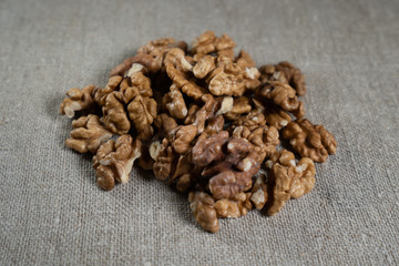 Peeled walnut on burlap, closeup