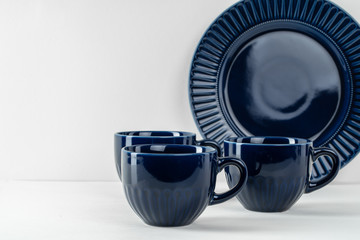 Simple ceramic blue crockery on kitchen counter. Tableware