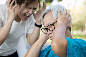 Angry asian daughter shouting scolding at her senior mother about fussy things,nag,so...