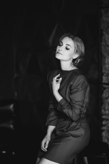 Beautiful romantic woman lady in a red dress in a room in the loft style. Soft selective focus. Beauty, fashion.