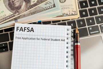 Fafsa in the notebook and money near