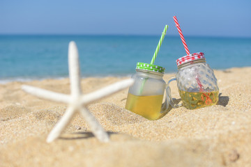 Cold refreshment on sandy beach.  Summer holidays background, concept of vacations