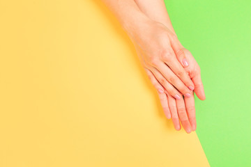 female  manicure. Beautiful young woman's hands on pastel color  background - Image