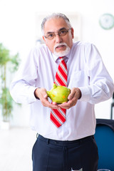 Fototapeta premium Old male accountant in budget planning concept