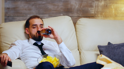Overworked businessman sitting on couch
