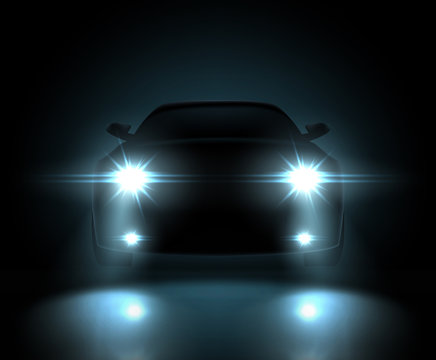 Dark silhouette of car with headlights