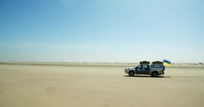 Offroad driving, SUV is driving on high speed across the desert in Namibia