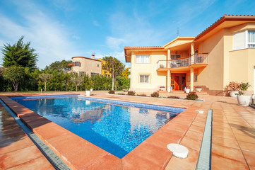 Fototapeta na wymiar Classic new home with pool. Real estate Luxury exterior design pool villa