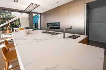 Luxury modern kitchen with marble worktop, modern kitchen sink. - obrazy, fototapety, plakaty