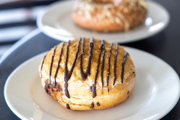 Chocolate donuts on white plate