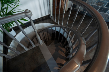 Classic spiral staircase with wooden steps and railing