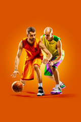 Fototapeta na wymiar colourful professional basketball players isolated over orange background