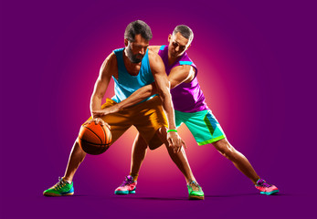 colourful professional basketball players isolated over purple background