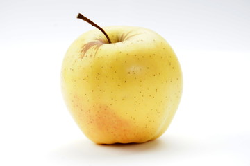 Fresh yellow apple on a light background