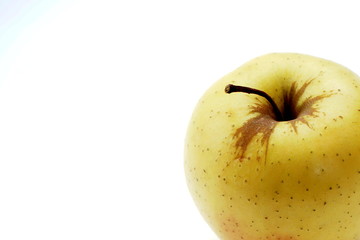 Fresh yellow apple on a light background