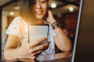 Woman hand use smartphone to do work business, social network, communication in public.