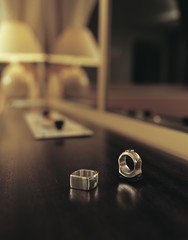 Close up of two rings on a side board in a hotel room
