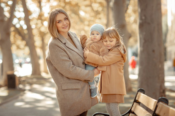 Fototapeta premium Mother and child on a walk in a public park hugs and kisses