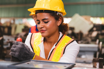 Industrial factory maintenance engineers dark skinned woman inspect relay protection system of...