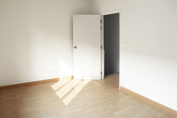 Empty White room with open door. White Interior on wooden floor.