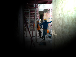 worker is rest in construction site, photo is film grain style and black space area for input text