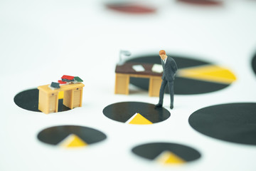 Miniature people businessman standing with table work desk on chart for analysis business