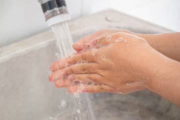Woman hands washing with soup on sinks.sensitive focus